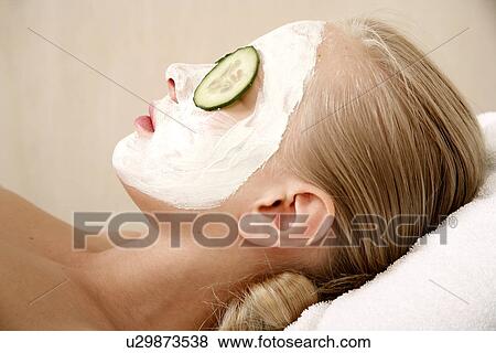 Stock Photo - Woman having a facial treatment in a spa. Fotosearch