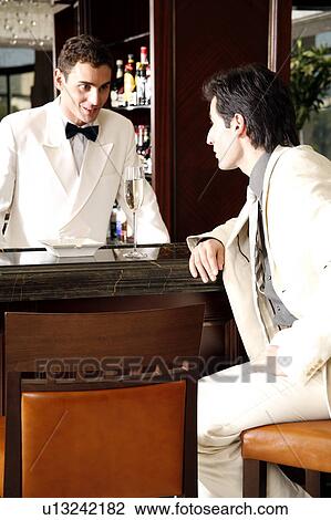 Bartender talking with guest View Large Photo Image Stock Image - Bartender talking with guest. Fotosearch