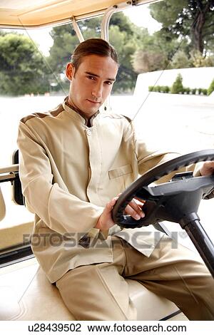 Bellboy driving hotel cart View Large Photo Image Stock Image - Bellboy driving hotel cart. Fotosearch