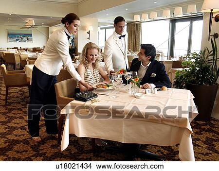 Picture - Couple being served in a restaurant. Fotosearch