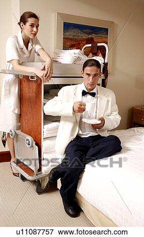 Hotel maid and waiter taking a break View Large Photo Image Stock Photo - Hotel maid and waiter taking a break. Fotosearch