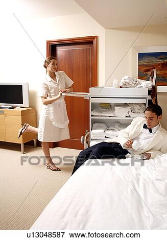 Hotel maid and waiter taking a break View Large Photo Image Stock Photo - Hotel maid and waiter taking a break. Fotosearch