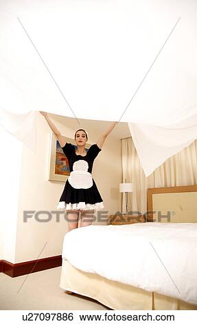 Hotel maid making the bed View Large Photo Image Stock Photograph - Hotel maid making the bed. Fotosearch