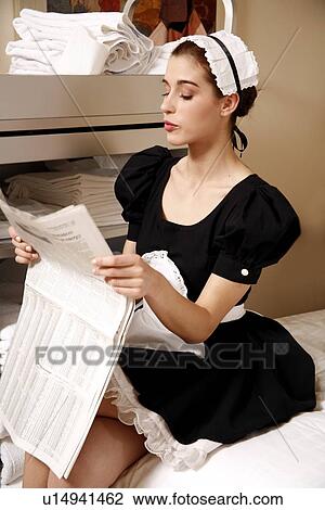 Stock Image - Hotel maid taking a break. Fotosearch