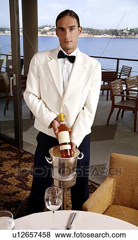 Waiter displaying wine bottle View Large Photo Image Stock Photo - Waiter displaying wine bottle. Fotosearch