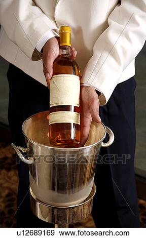 Waiter displaying wine bottle View Large Photo Image Stock Photo - Waiter displaying wine bottle. Fotosearch