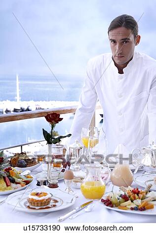 Waiter with breakfast table View Large Photo Image Stock Image - Waiter with breakfast table . Fotosearch
