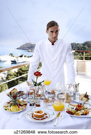 Waiter with breakfast table View Large Photo Image Stock Photo - Waiter with breakfast table . Fotosearch