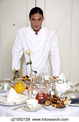 Stock Photo - Waiter with room service breakfast table . Fotosearch