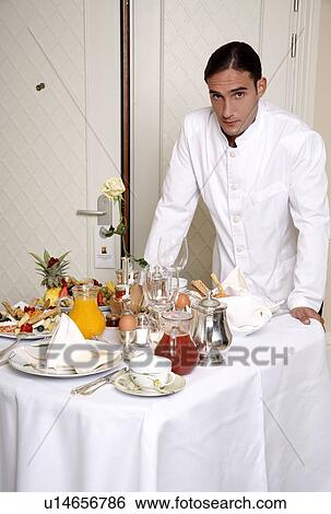 Waiter with room service breakfast table View Large Photo Image Stock Photograph - Waiter with room service breakfast table . Fotosearch