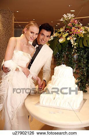 Bride and groom cutting their cake View Large Photo Image Stock Photograph - Bride and groom cutting their cake. Fotosearch