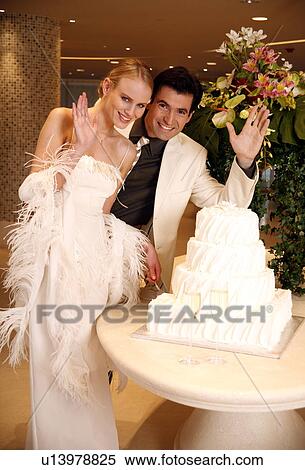 Bride and groom cutting their cake View Large Photo Image Stock Photography - Bride and groom cutting their cake. Fotosearch