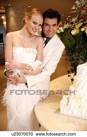 Bride and groom with cake View Large Photo Image Stock Image - Bride and groom with cake. Fotosearch