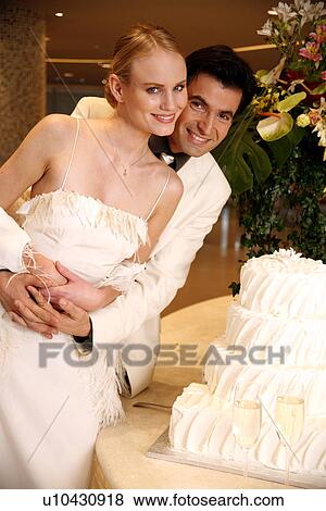Bride and groom with cake View Large Photo Image Stock Photo - Bride and groom with cake. Fotosearch