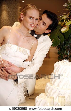 Bride and groom with cake View Large Photo Image Stock Photo - Bride and groom with cake. Fotosearch