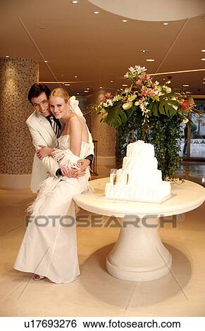 Bride and groom with cake View Large Photo Image Stock Photograph - Bride and groom with cake. Fotosearch