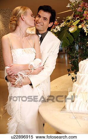 Bride and groom with cake View Large Photo Image Stock Photography - Bride and groom with cake. Fotosearch