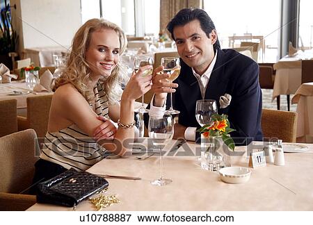 Couple drinking wine in a restaurant View Large Photo Image Stock Photo - Couple drinking wine in a restaurant. Fotosearch