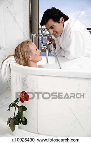 Stock Image - Couple enjoying bubble bath. Fotosearch