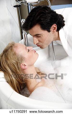 Stock Image - Couple enjoying bubble bath. Fotosearch