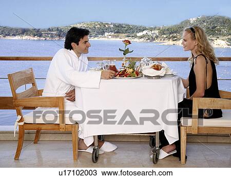 Couple having breakfast on hotel terrace View Large Photo Image Stock Image - Couple having breakfast on hotel terrace. Fotosearch