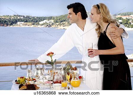 Couple having breakfast on hotel terrace View Large Photo Image Stock Photo - Couple having breakfast on hotel terrace. Fotosearch