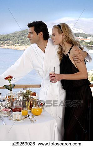 Stock Photograph - Couple having breakfast on hotel terrace. Fotosearch