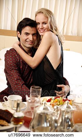 Couple having room service breakfast in hotel room View Large Photo Image Stock Photo - Couple having room service breakfast in hotel room. Fotosearch