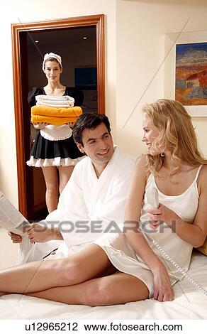 Couple on bed in hotel room View Large Photo Image Stock Image - Couple on bed in hotel room. Fotosearch
