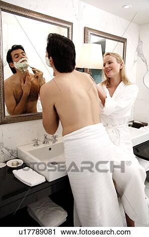 Couple sharing bathroom together View Large Photo Image Stock Image - Couple sharing bathroom together. Fotosearch