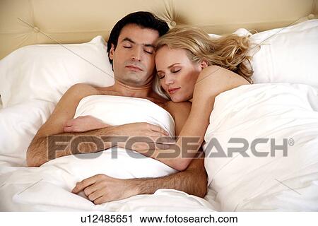 Couple sleeping in bed View Large Photo Image Stock Image - Couple sleeping in bed. Fotosearch