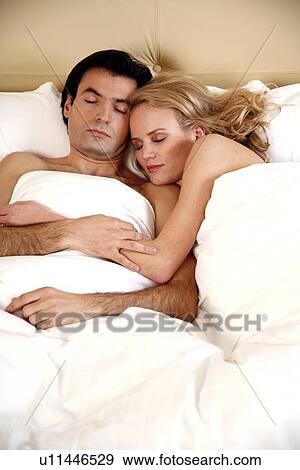 Couple sleeping in bed View Large Photo Image Stock Photo - Couple sleeping in bed. Fotosearch