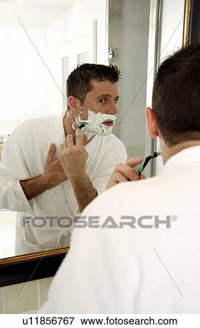 Man shaving in front of mirror View Large Photo Image Stock Photo - Man shaving in front of mirror. Fotosearch