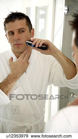 Man shaving in front of mirror View Large Photo Image Stock Photo - Man shaving in front of mirror. Fotosearch