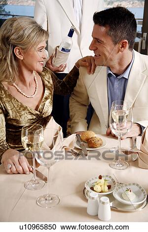 Stock Image - Mature couple dining in a restaurant. Fotosearch