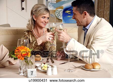 Stock Image - Mature couple dining in a restaurant. Fotosearch