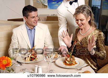 Stock Photograph - Mature couple dining in a restaurant. Fotosearch