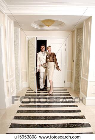 Stock Photo - Mature couple entering a hotel suite. Fotosearch