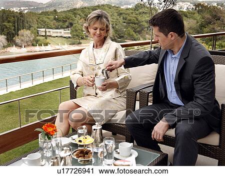 Mature couple having beverages on hotel terrace View Large Photo Image Stock Image - Mature couple having beverages on hotel terrace. Fotosearch