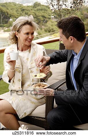 Mature couple having beverages on hotel terrace View Large Photo Image Stock Photograph - Mature couple having beverages on hotel terrace. Fotosearch