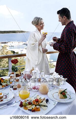 Mature couple having breakfast on hotel terrace View Large Photo Image Stock Photograph - Mature couple having breakfast on hotel terrace. Fotosearch