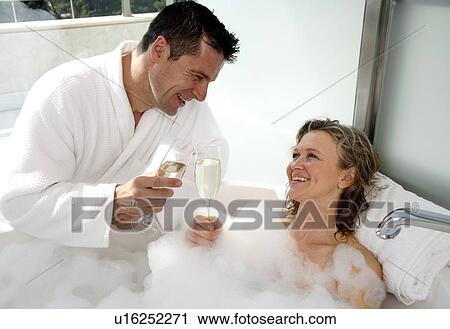 Stock Image - Mature couple having fun in the bathtub. Fotosearch