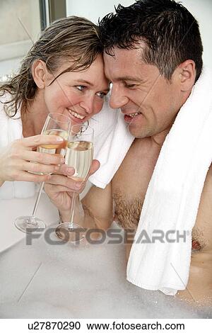 Stock Image - Mature couple having fun in the bathtub. Fotosearch