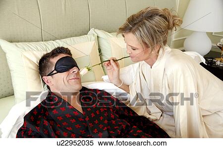 Stock Photography - Mature couple relaxing in bed. Fotosearch