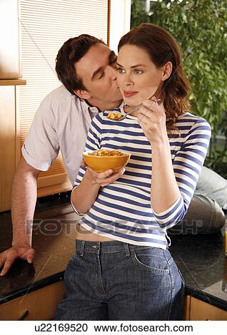 Stock Image - A young couple eating breakfast. Fotosearch
