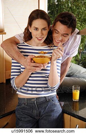 A young couple eating breakfast View Large Photo Image Stock Photograph - A young couple eating breakfast. Fotosearch