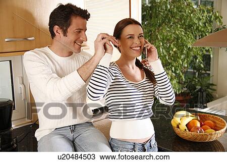 Stock Image - A young couple in the kitchen. Fotosearch