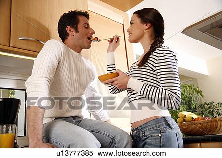 A young couple in the kitchen View Large Photo Image Stock Photography - A young couple in the kitchen. Fotosearch