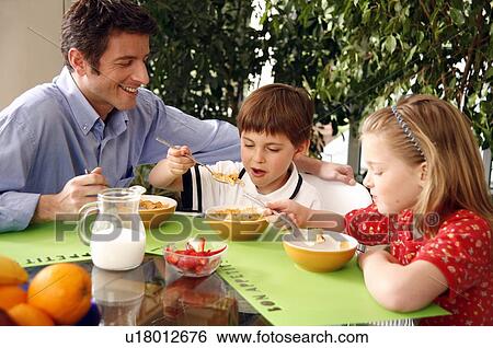 Father and children eating breakfast View Large Photo Image Stock Photograph - Father and children eating breakfast. Fotosearch
