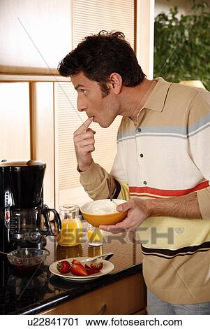 Man eating his breakfast View Large Photo Image Stock Image - Man eating his breakfast. Fotosearch